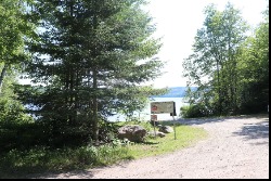 Image of sign and boat launch parking.