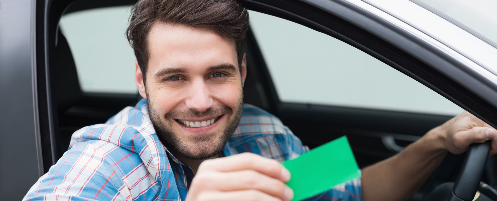 Person in a vehicle holding a landfill card