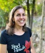 Image of Karen Gervais - should length brown hair, smiling, wearing a black Red Hawks t-shirt.